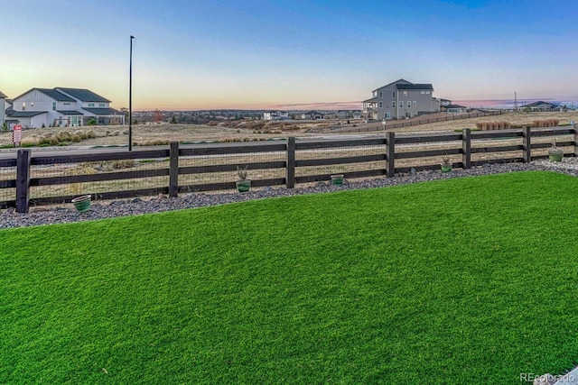 view of yard at dusk