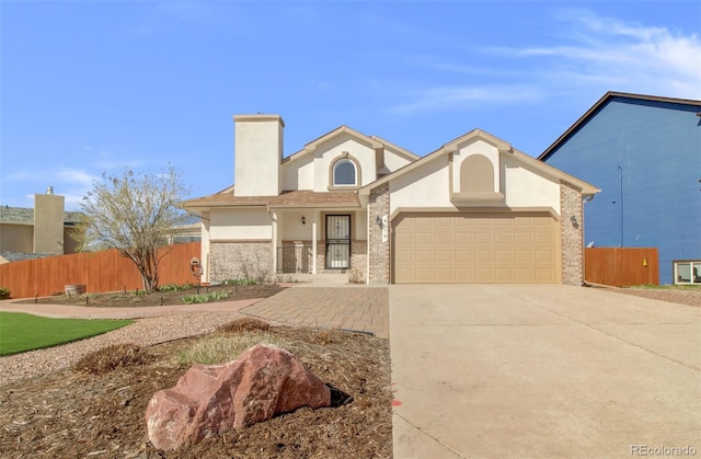view of front of home with driveway, a chimney, a garage, and fence