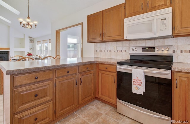 kitchen with white microwave, tasteful backsplash, a peninsula, a chandelier, and stainless steel electric range
