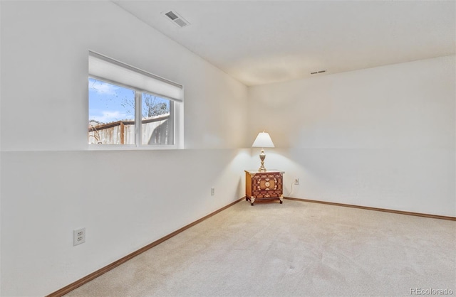 unfurnished room with visible vents, baseboards, and carpet floors