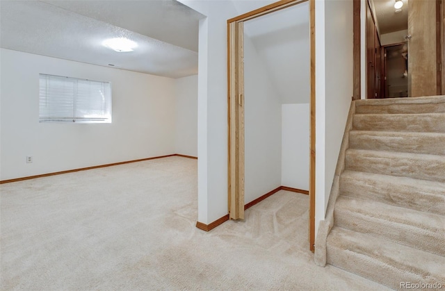 stairway featuring carpet flooring and baseboards