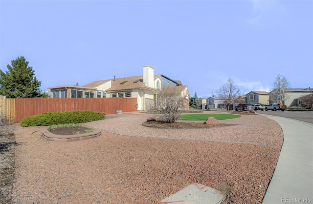view of yard featuring driveway and fence