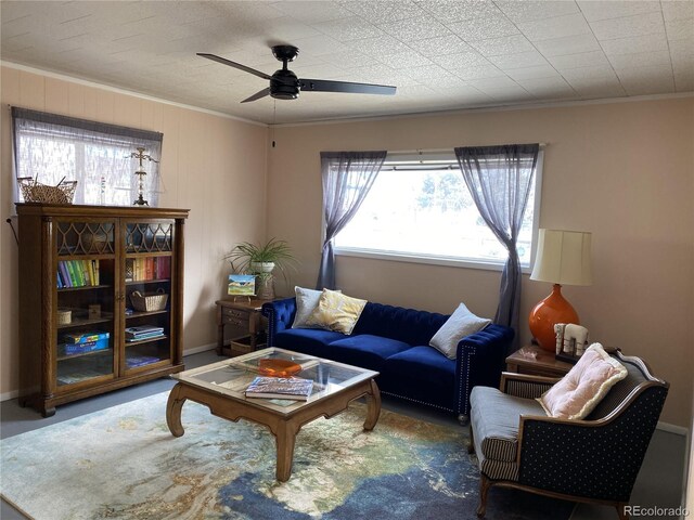 living room with ceiling fan and crown molding