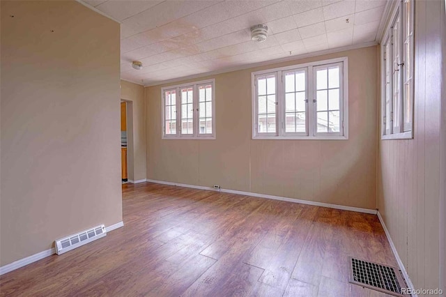 unfurnished room with hardwood / wood-style flooring