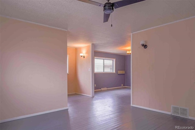 spare room featuring ceiling fan, wood-type flooring, and a textured ceiling