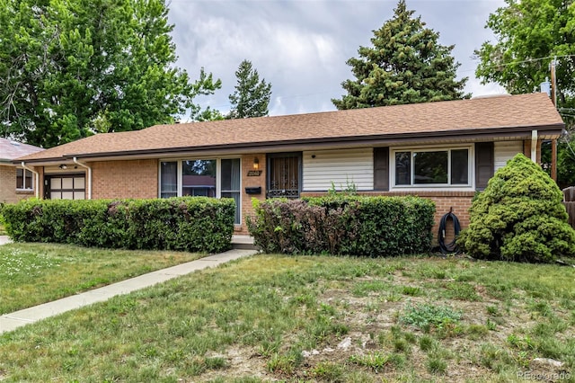 2061 S Stuart St, Denver, CO 80219 - ranch-style home featuring brick siding, a front yard, and an attached garage