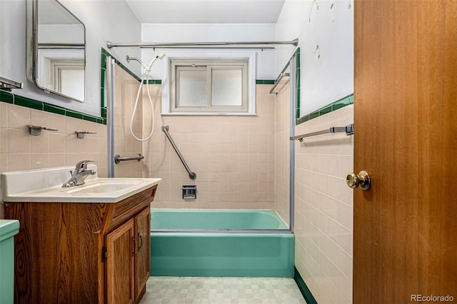 2061 S Stuart St, Denver, CO 80219 - full bath featuring tile walls, washtub / shower combination, and vanity