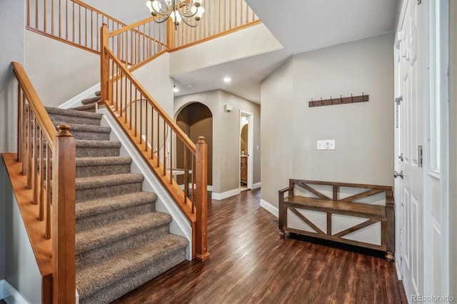 foyer featuring an inviting chandelier and dark hardwood / wood-style flooring