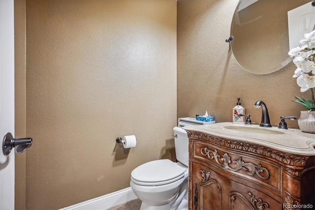 bathroom with vanity, toilet, and tile patterned floors