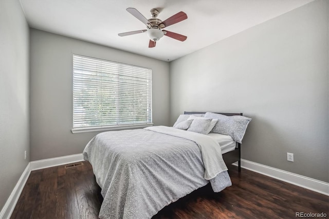 bedroom with dark wood-type flooring and ceiling fan