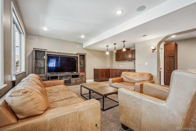 living room with plenty of natural light and light colored carpet