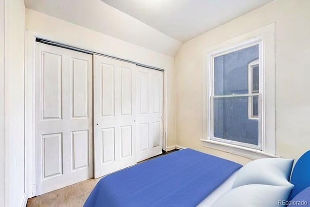 2350 N Ogden St, Denver, CO 80205 - carpeted bedroom featuring a closet and vaulted ceiling