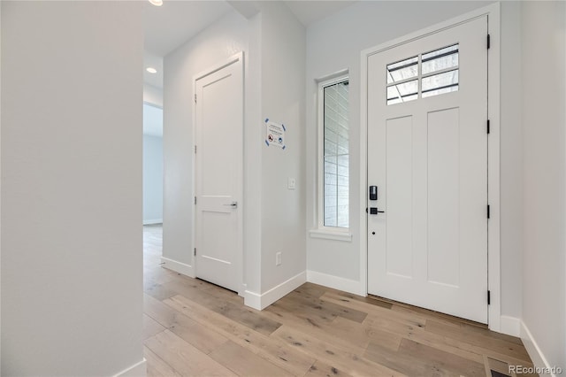 foyer entrance with light hardwood / wood-style floors