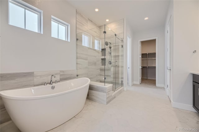 bathroom with vanity and independent shower and bath