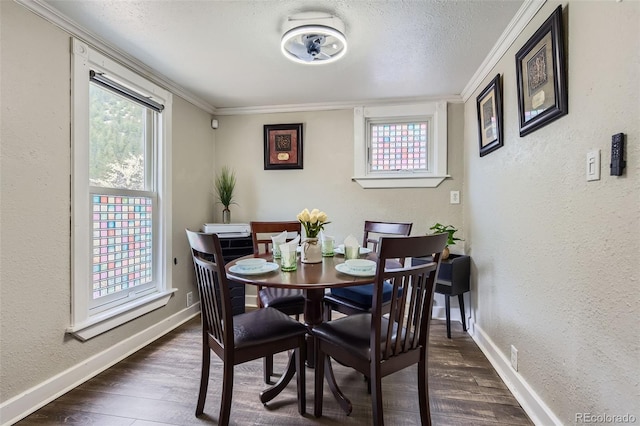 dining room featuring a textured wall, dark wood-style flooring, baseboards, crown molding, and a textured ceiling