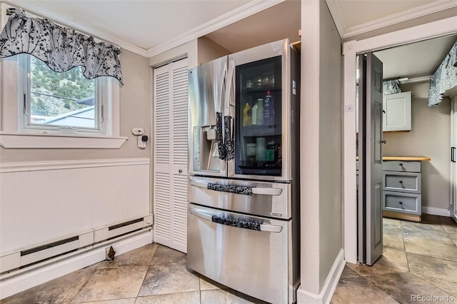 kitchen featuring stainless steel fridge, crown molding, a baseboard radiator, light stone finish floors, and baseboards