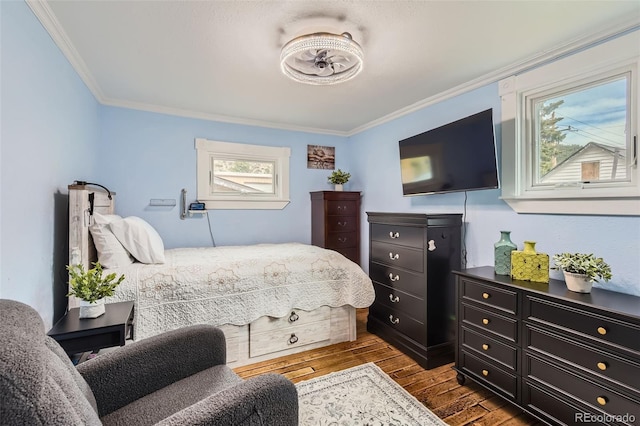 bedroom with crown molding and dark wood finished floors
