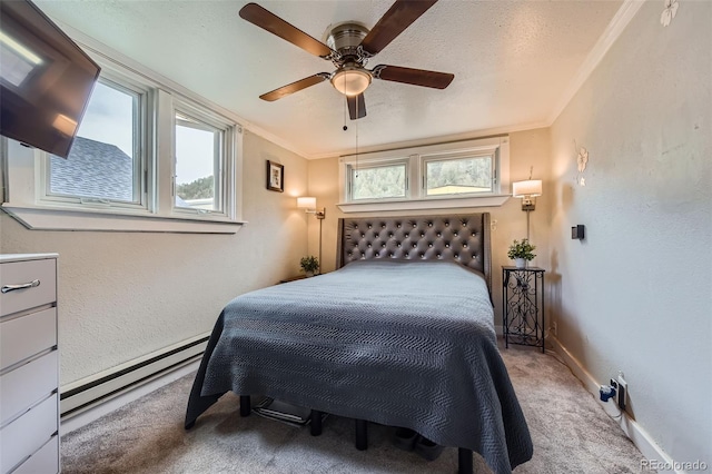 bedroom with a baseboard heating unit, carpet, crown molding, baseboards, and a textured wall