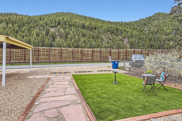 view of yard with a view of trees