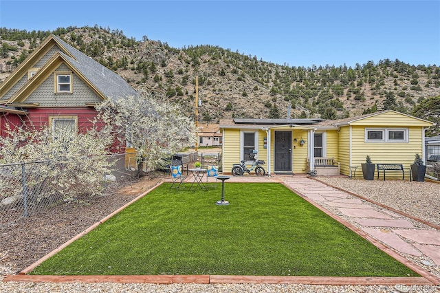 view of front of house with solar panels and a mountain view