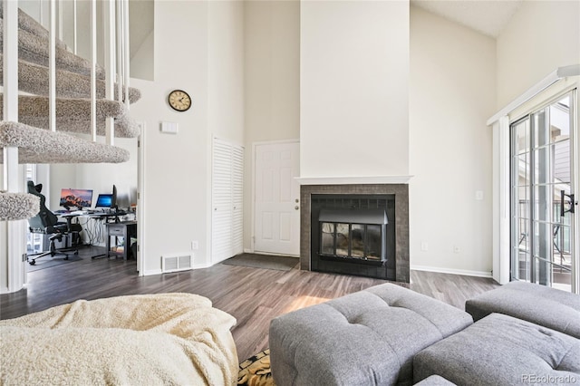 13873 E Lehigh Ave Unit C, Aurora, CO 80014 - living room featuring high vaulted ceiling, plenty of natural light, wood finished floors, a fireplace, and an office area