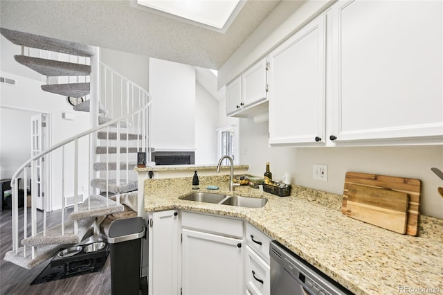 13873 E Lehigh Ave Unit C, Aurora, CO 80014 - kitchen featuring dark wood-style floors, white cabinets, light stone counters, and a peninsula
