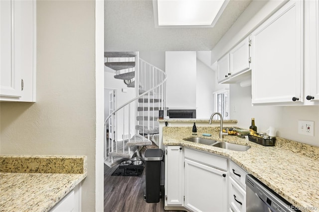 13873 E Lehigh Ave Unit C, Aurora, CO 80014 - kitchen featuring stainless steel dishwasher, white cabinetry, and light stone counters