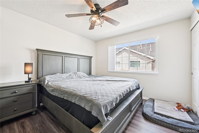 13873 E Lehigh Ave Unit C, Aurora, CO 80014 - bedroom with dark wood-style floors, a textured ceiling, and a ceiling fan