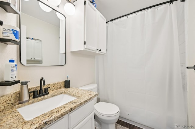 13873 E Lehigh Ave Unit C, Aurora, CO 80014 - bathroom featuring vanity, curtained shower, and wood finished floors