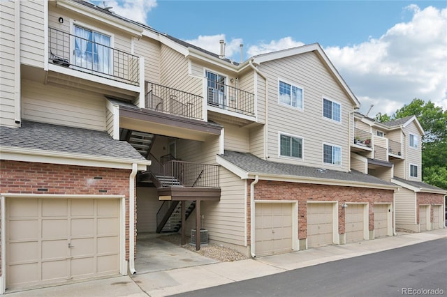 13873 E Lehigh Ave Unit C, Aurora, CO 80014 - view of property with stairway and an attached garage