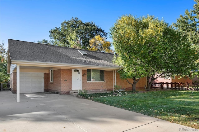 view of front of home featuring fence, a front yard, brick siding, concrete driveway, and an attached garage