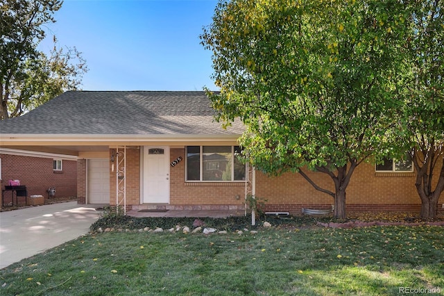 view of front of home featuring concrete driveway, brick siding, a garage, and a front lawn
