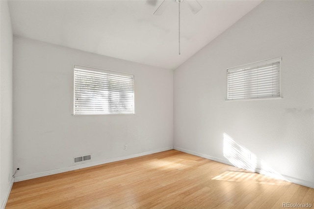 empty room featuring baseboards, a ceiling fan, wood finished floors, and lofted ceiling