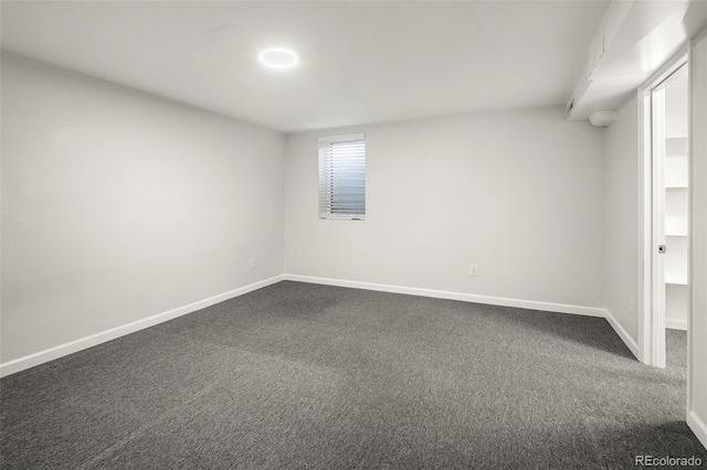 interior space with baseboards and dark colored carpet