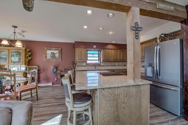 311 Longs Rd, Silverthorne, CO 80498 - kitchen with stainless steel fridge, recessed lighting, light wood-style flooring, light stone counters, and a kitchen island