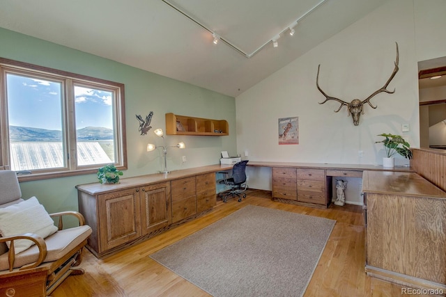 311 Longs Rd, Silverthorne, CO 80498 - home office with track lighting, built in desk, vaulted ceiling, and light wood-style floors