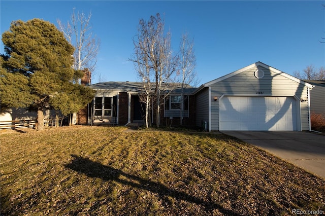 ranch-style home with a garage and a front yard