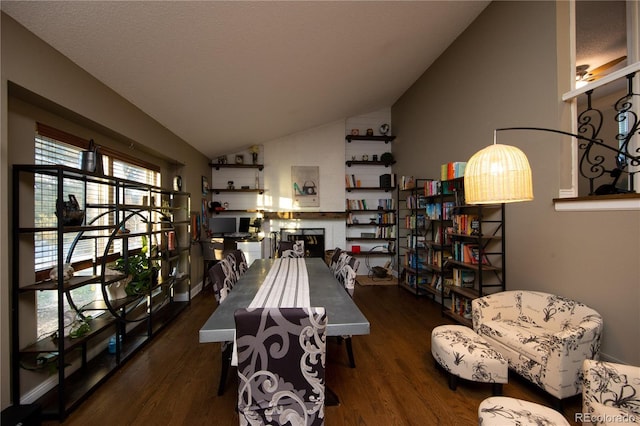 dining space with lofted ceiling and dark hardwood / wood-style floors