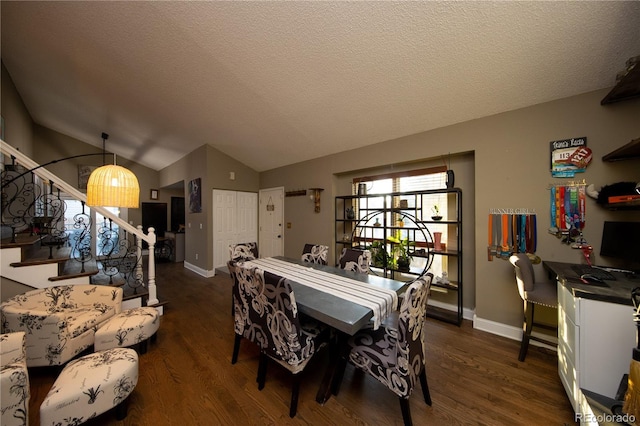 dining space with vaulted ceiling, a textured ceiling, and dark hardwood / wood-style flooring