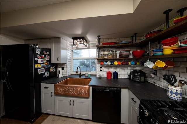 kitchen with white cabinetry, sink, decorative backsplash, and black appliances