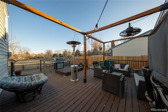 wooden terrace featuring area for grilling and an outdoor hangout area