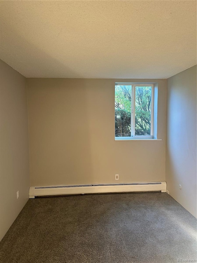 unfurnished room with baseboard heating, carpet, and a textured ceiling