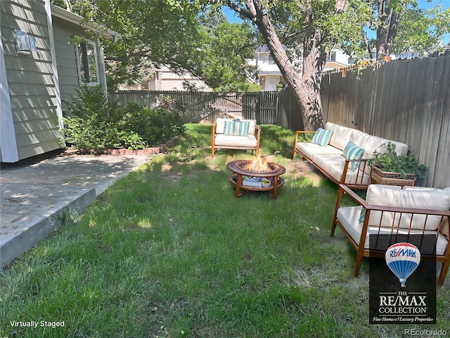 5612 S Lansing Ct, Englewood, CO 80111 - view of yard with an outdoor living space with a fire pit and a patio area