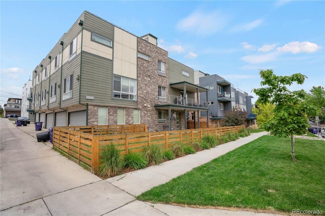 1921 Hooker St, Denver, CO 80204 - view of property featuring a fenced front yard and an attached garage