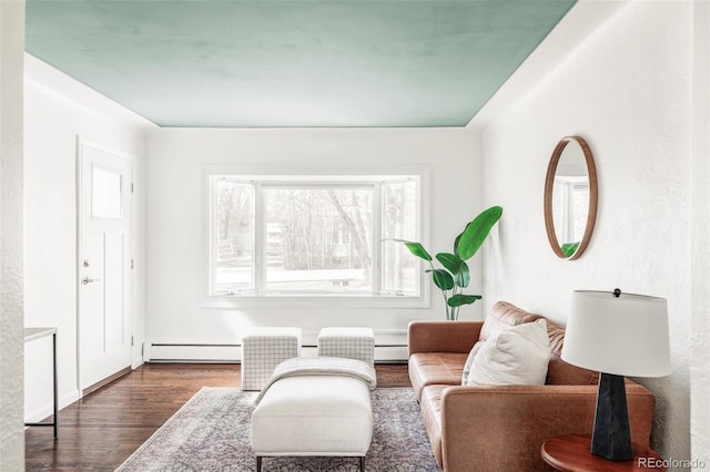 living area featuring a baseboard radiator, dark wood-type flooring, and baseboard heating