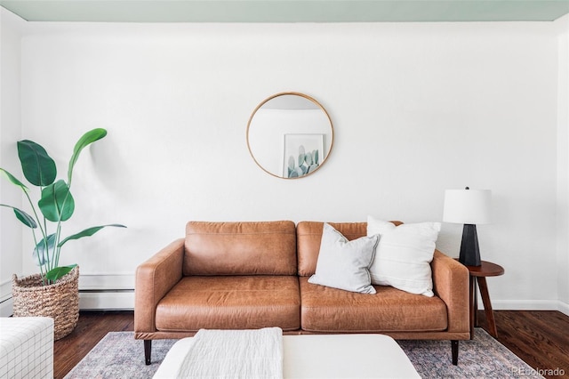 living area with baseboards, baseboard heating, and wood finished floors