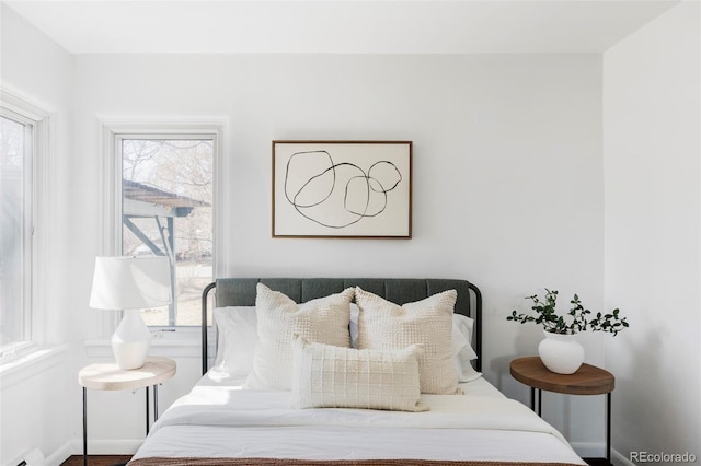 bedroom with a baseboard radiator and baseboards