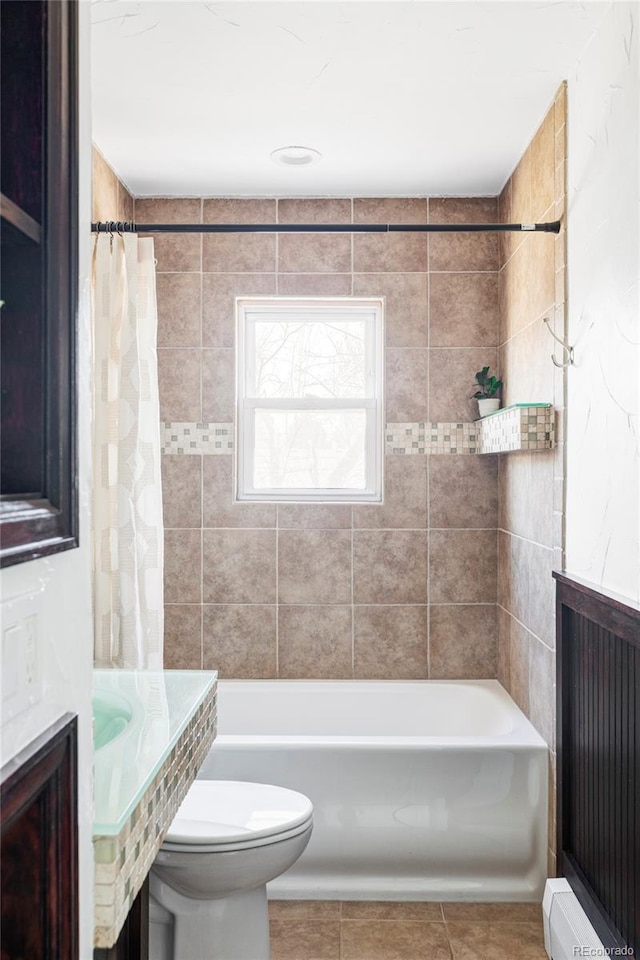 bathroom featuring tile patterned flooring, shower / bath combination with curtain, and toilet