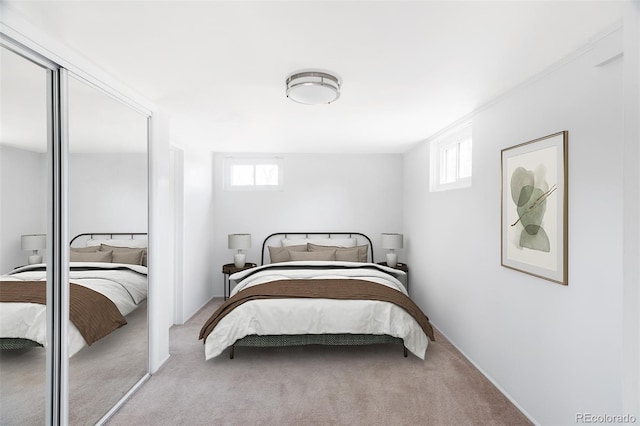 carpeted bedroom with multiple windows and a closet