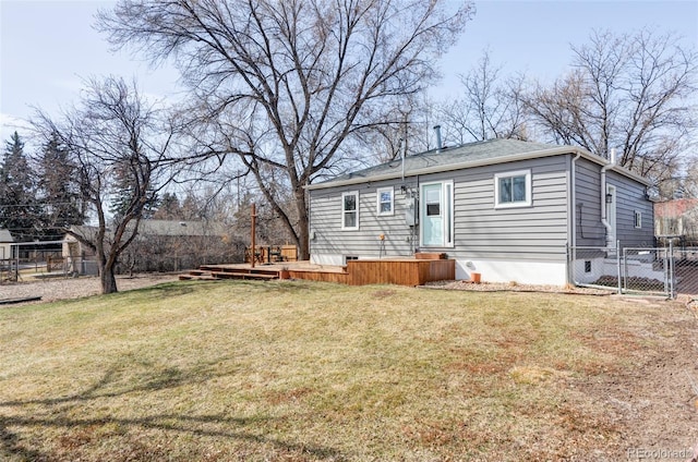 back of house with crawl space, fence, a lawn, and a wooden deck